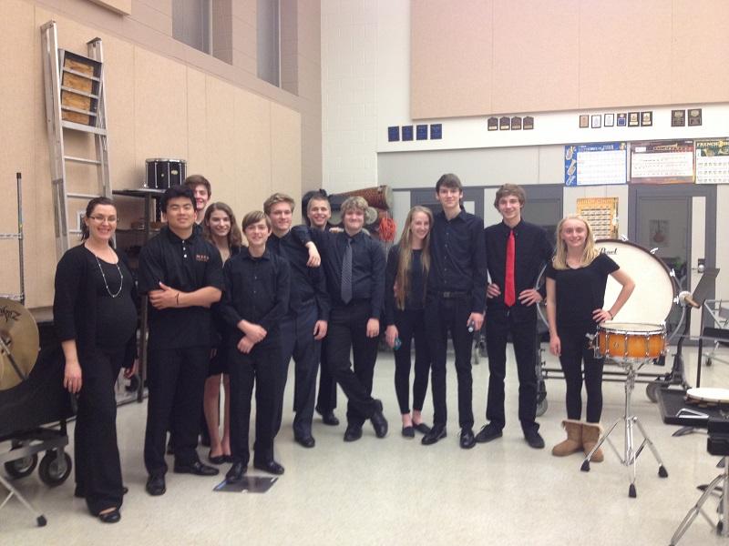 The Jazz band collected in the band room after a great concert.