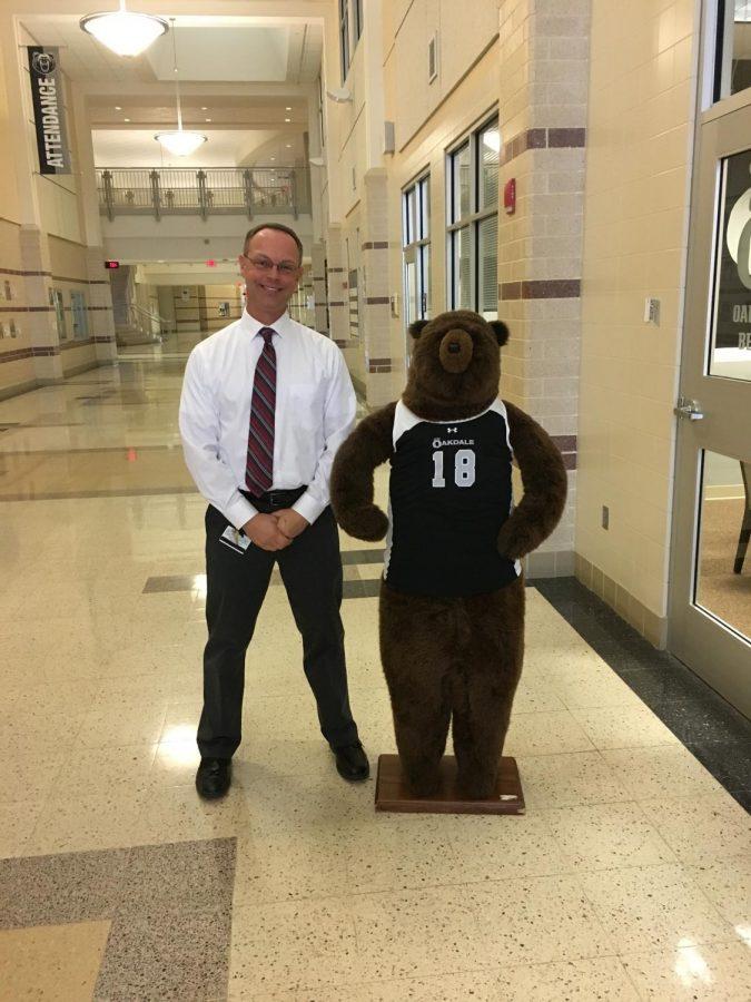 Mr. Hombach poses with Harvey on Mainstreet. 

