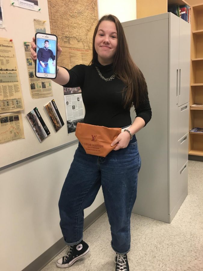 Throwing back to the late 90’s Junior Megan Scheulien dresses as Dwayne Jhonson posing with a picture and rocking the old school fanny pack.