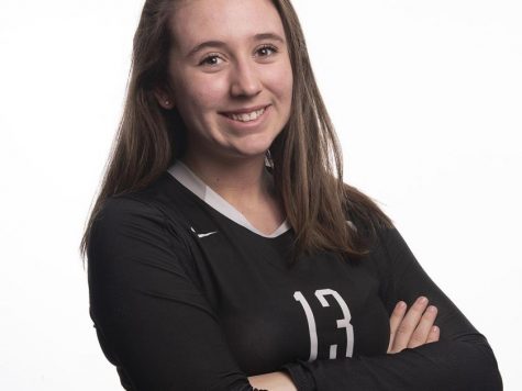 Sydney Katz happily poses for her yearly volleyball photo.