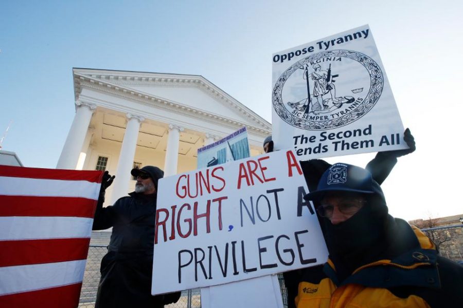 Protestors stand outside the Virginia capitol building to protest against gun restrictions.  
