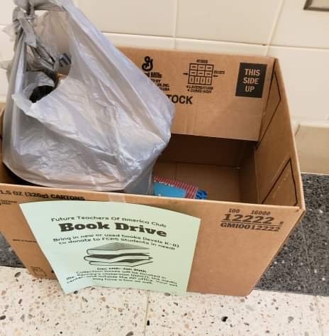 Students can donate books to the boxes with green flyers on them.