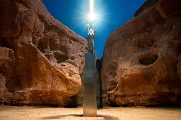 An unidentified person standing on top of the Monolith in Utah before it mysteriously disappeared.