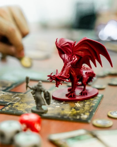 Figurines of a player’s character and a dragon enemy laid out on a map for a game of D&D. Sometimes people like to have visual representations of in-game characters and locations while playing.
