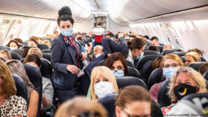 Passengers masked up on a busy flight departing from an airport in the Netherlands, in June 2020.