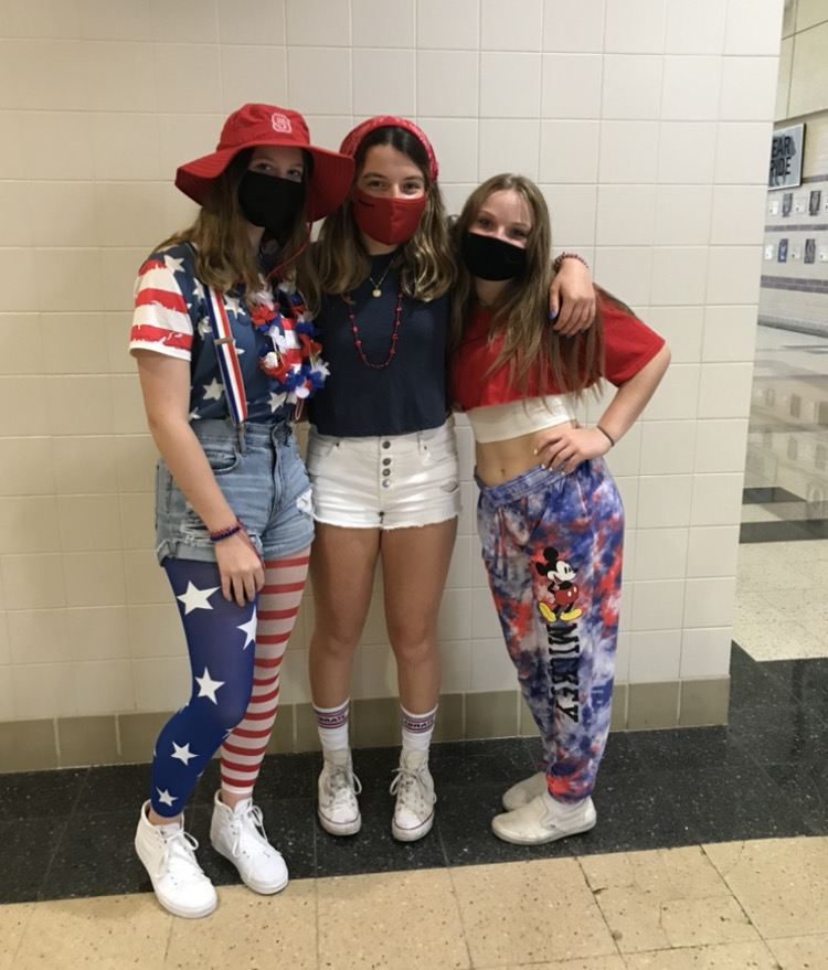 Juniors Kelly Banks, Zoe Vance, and senior Allie Sheetz show their spirit wear on America Monday.
