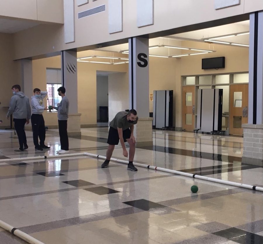 Student Eric Connolly, a senior, is showing his bocce skills after school