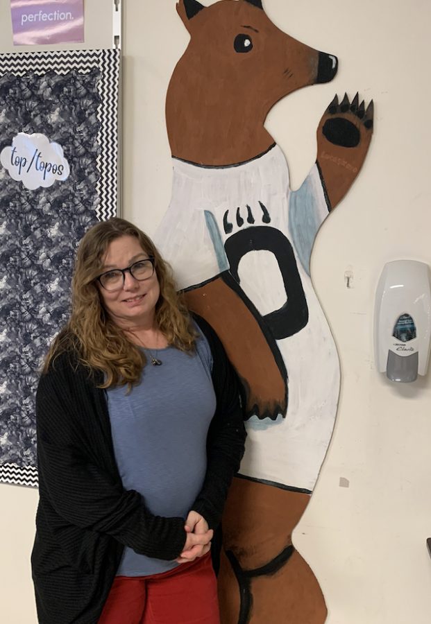  Mrs. Storm poses in front of her classroom painted bear.