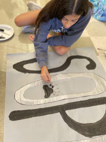 Sophomore and member of student Government, Krisha Brahmbhatt, painting a “sophomore” poster for pep rally.