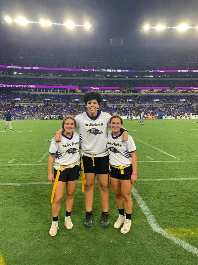 Emily Meyer, Layla McFarland, and Grace Meyer at Ravens stadium during a preseason game, practicing scrimmages to prepare for the season.