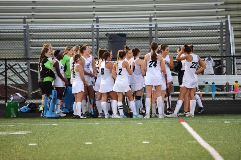 Oakdale’s varsity field hockey team huddles to discuss strategy before their game against Manchester Valley.