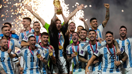 Argentina’s Lionel Messi holds up the FIFA World Cup 2022 trophy.