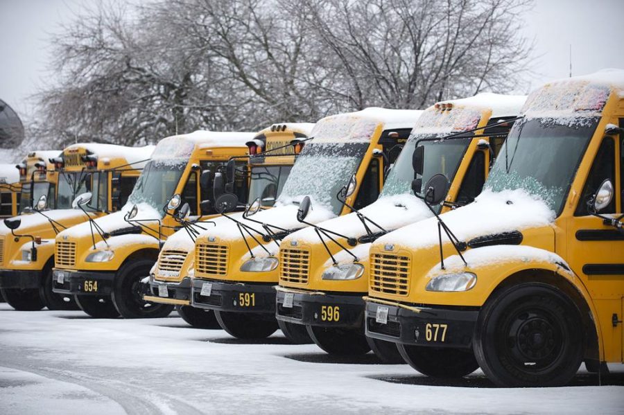 A+line+of+snow-covered+Maryland+school+buses+on+a+inclement+weather+day.