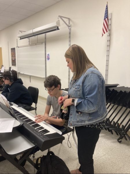 Ms. Grimm teaches a student (Milo) how to play chords on piano.