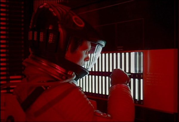 A frame from Stanley Kubrick and Arthur C. Clarke’s 2001: A Space Odyssey, featuring astronaut David Bowman (Keir Dullea) and the Artificial Intelligence known as HAL-9000 (Famously voiced by Douglas James Rain) as he attempts to disarm the villainous computer.