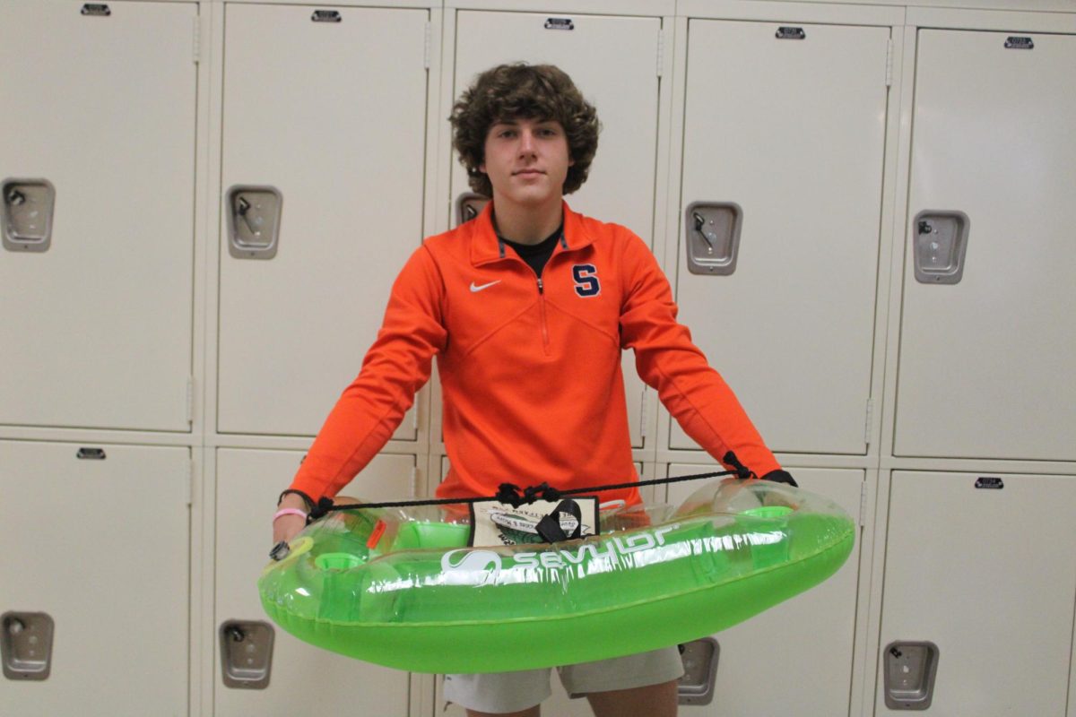 Sophomore Owen Fay used an inflatable pool float to carry his belongings on spirit day: Anything But a Backpack.