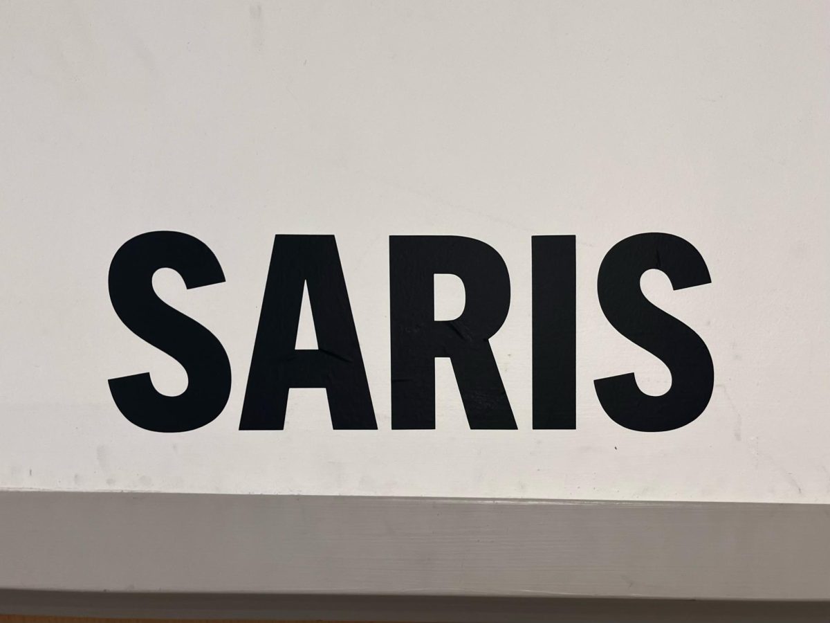Mr. Saris’s name, printed above the door to room A223, featured for the first time outside of his own classroom. 

