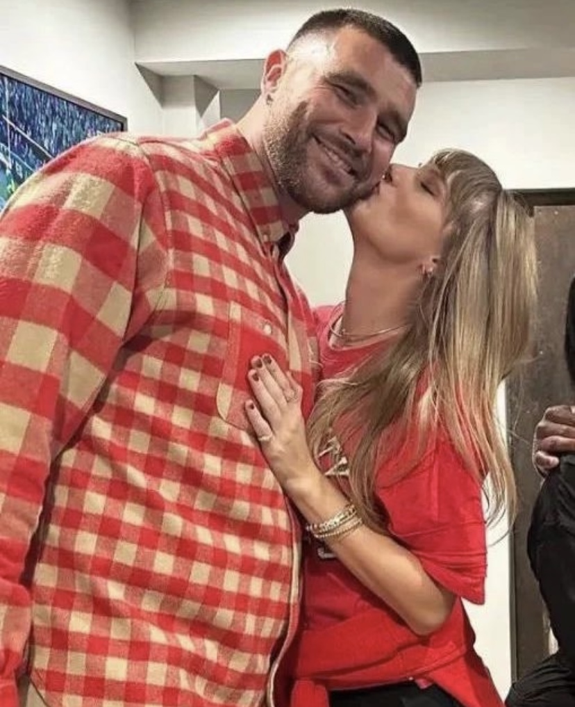 Taylor Swift and Travis Kelce pose together for paparazzi after a Chiefs game. 