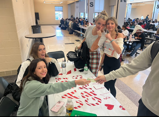 Juniors Bella Signor and Macey Whyte work during lunch shifts for Candy Grams.