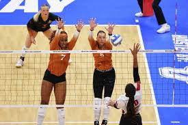  Junior Madisen Skinner and Senior Asjia O’Neal block a ball at the net against Wisconsin in the  2023 NCAA volleyball final four game.  
