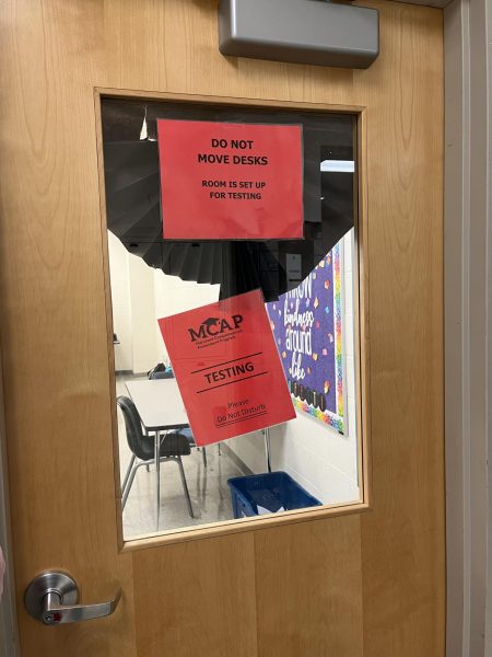 A poster outside the classroom B200 informs that testing is currently taking place inside.