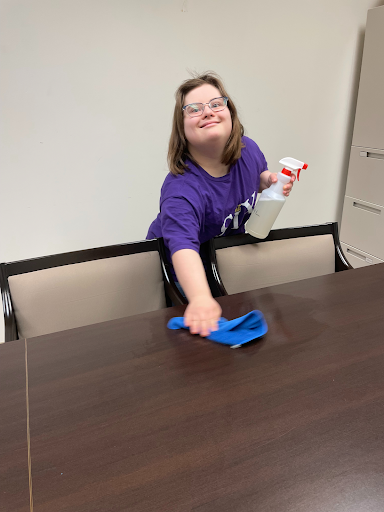Abbey Ware, an L4L student, wipes off a table as she takes part in the Fit 2 Work custodial project. 