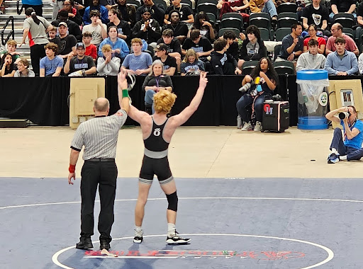 Oakdales 132 lbs wrestler Cooper VanScoyoc victory poses after winning his finals match at the states tournament. 
