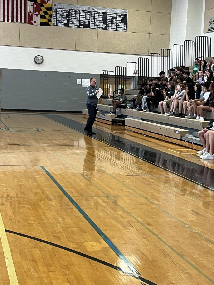 Athletic Director, Mark Wolcott, speaks to the rising freshman at the gym