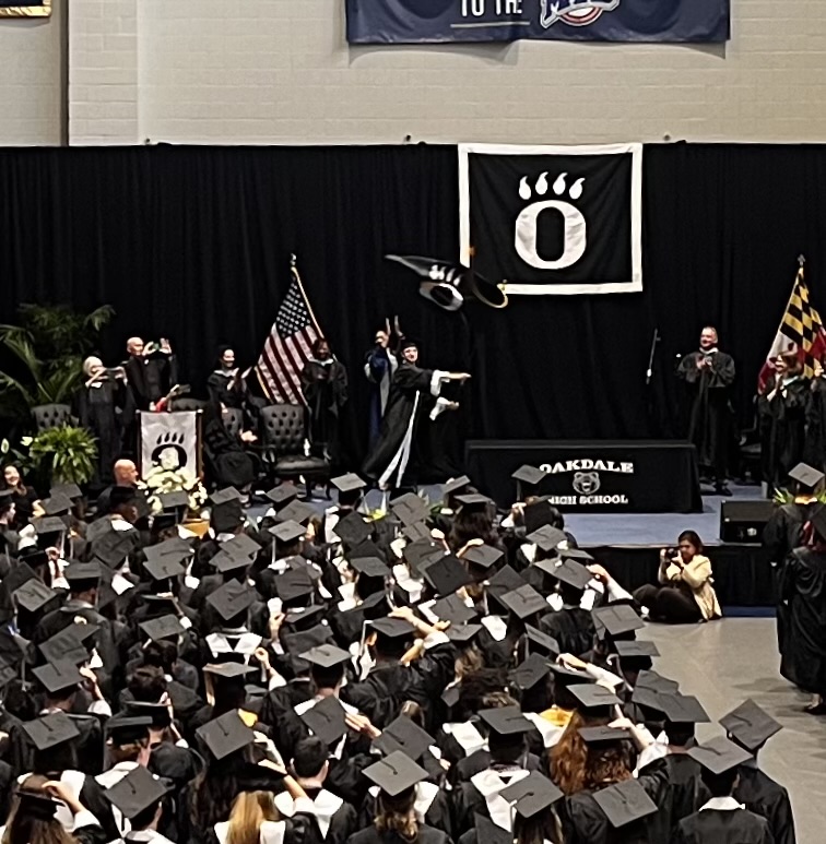 Senior Alex Beck waves the Oakdale flag to signify the end of the Graduation Ceremony.