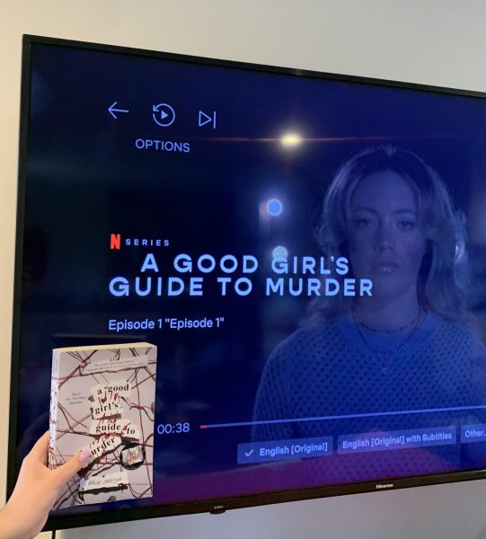 The 'A Good Girl’s Guide to Murder' book, written by Holly Jackson pictured in front of a TV showing the Netflix series it was adapted into.