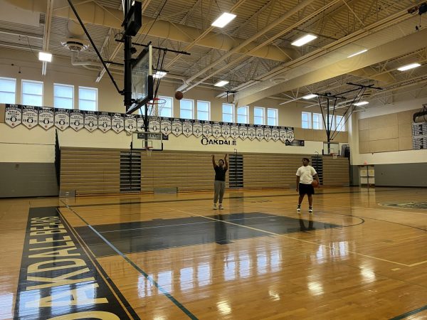 Two Oakdale High School students playing basketball during the school day. 