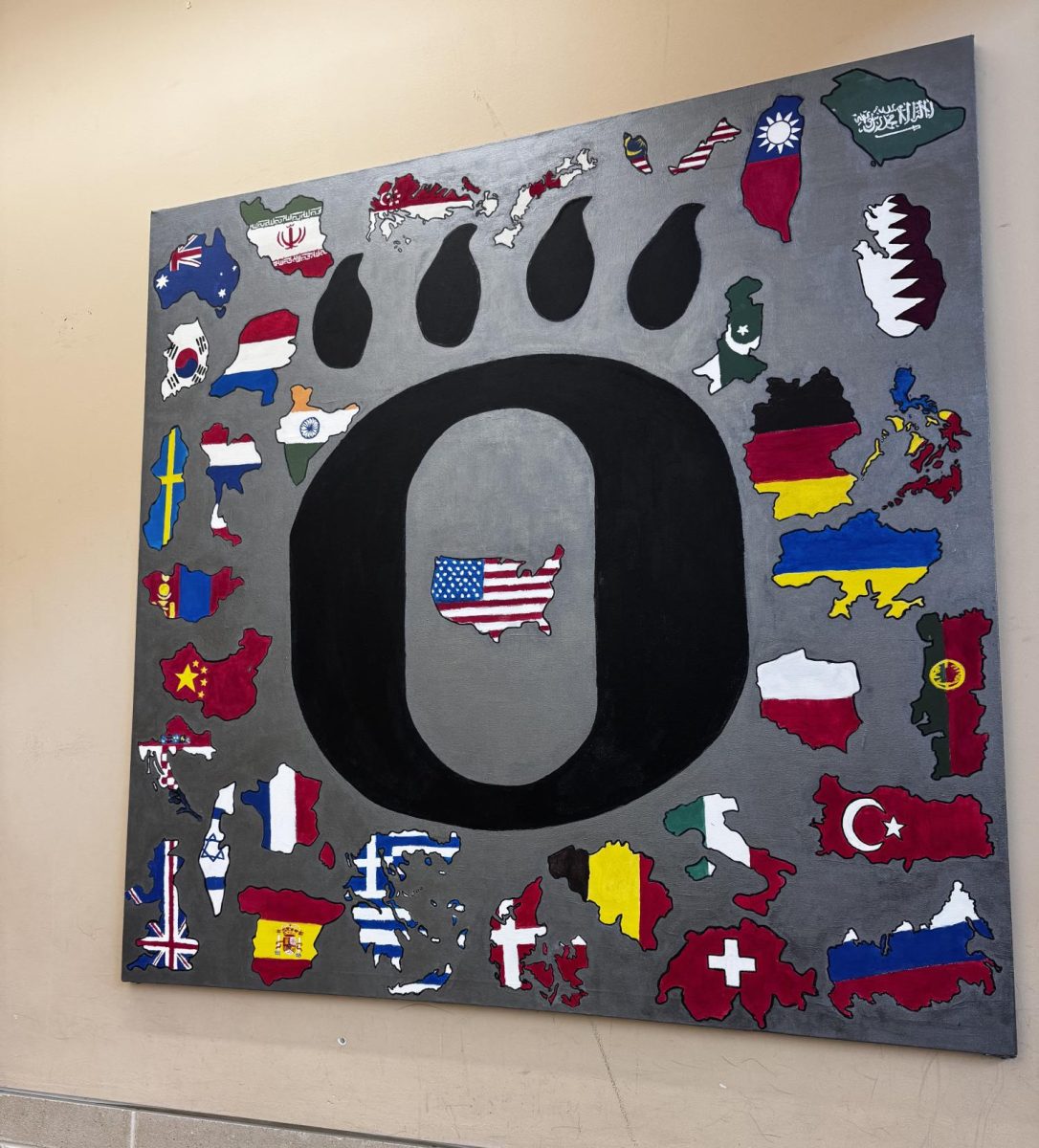 This piece of art, designed by Oakdale's multicultural club, hangs in the school's cafeteria, representing the school's dedication to diversity and inclusion.