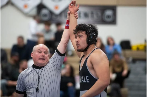 Oakdale’s Kauser Kaiser, right, receiving his win against Frederick in the 215 pound match.